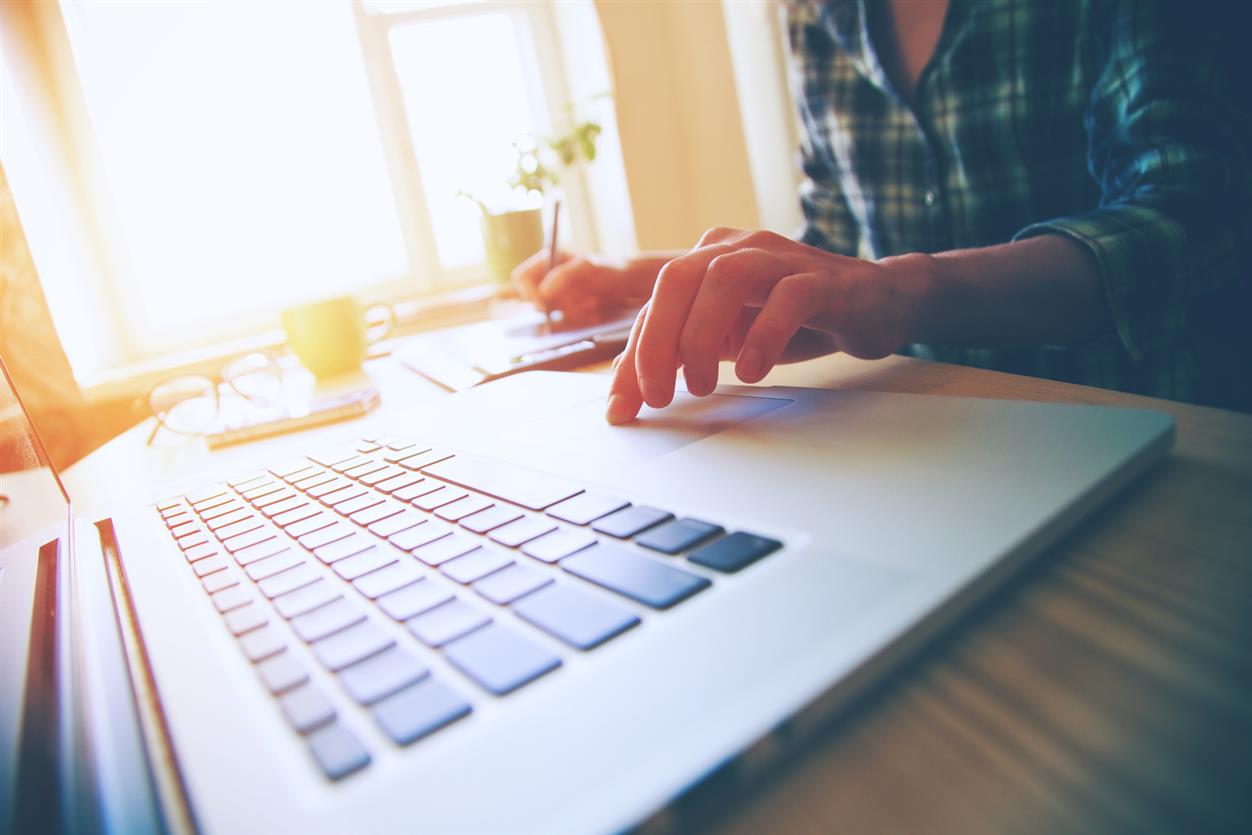 hands with laptop and tablet at table